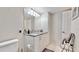 Clean bathroom with granite countertops, bright lighting, and white cabinetry and tile at 4900 Brittany S Dr # 1011, St Petersburg, FL 33715