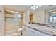 Updated bathroom with granite vanity top, glass enclosed shower, and modern fixtures at 4900 Brittany S Dr # 1011, St Petersburg, FL 33715