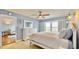 Bright bedroom featuring a full bed, ceiling fan, and large windows at 4900 Brittany S Dr # 1011, St Petersburg, FL 33715