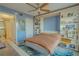 Comfortable bedroom featuring a ceiling fan, built-in shelves, and a bright blue accent rug at 4900 Brittany S Dr # 1011, St Petersburg, FL 33715