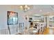 Bright kitchen with white cabinets, stainless steel appliances, and a glass dining table at 4900 Brittany S Dr # 1011, St Petersburg, FL 33715