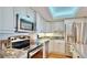Well-lit kitchen features stainless steel appliances, granite countertops, and white cabinetry at 4900 Brittany S Dr # 1011, St Petersburg, FL 33715