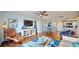 Bright living room with hardwood floors, modern furnishings, and an entertainment center at 4900 Brittany S Dr # 1011, St Petersburg, FL 33715
