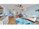 Well-lit living room with hardwood floors, modern furnishings, and a view of the kitchen at 4900 Brittany S Dr # 1011, St Petersburg, FL 33715