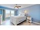 Bright bedroom with a ceiling fan, and large windows offering water views at 4900 Brittany S Dr # 1011, St Petersburg, FL 33715