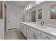 Elegant bathroom featuring double sinks, quartz countertops, and modern fixtures at 6982 Minneola Ct, Nokomis, FL 34275