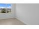 A modern bedroom with tile flooring, a large window and neutral walls offer comfortable space at 6982 Minneola Ct, Nokomis, FL 34275