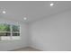 Bright bedroom with tile floors and a window with views of trees at 6982 Minneola Ct, Nokomis, FL 34275