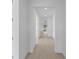 Long hallway features tile floors and leads to various rooms in the house at 6982 Minneola Ct, Nokomis, FL 34275
