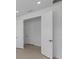 A light and bright hallway with white trim and doors leading to another area of the home at 6982 Minneola Ct, Nokomis, FL 34275