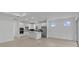 Bright, open kitchen with stainless steel appliances and a large island extending into the living area at 6982 Minneola Ct, Nokomis, FL 34275