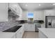 Close-up of kitchen showcasing stainless steel appliances, ample counter space, and stylish backsplash at 6982 Minneola Ct, Nokomis, FL 34275