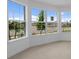 Bright living room featuring tile floors and large windows offering an abundance of natural light at 6982 Minneola Ct, Nokomis, FL 34275