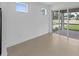 Light-filled room features tile floors, glass doors, and a view of the backyard at 6982 Minneola Ct, Nokomis, FL 34275
