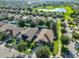 Aerial view of homes in a suburban neighborhood with lush landscaping and a pond at 12218 Avondale Oak Pl, Riverview, FL 33578