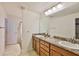 Bathroom featuring a double vanity with granite countertops and wood cabinets at 12218 Avondale Oak Pl, Riverview, FL 33578