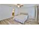 Bright bedroom featuring wood floors, neutral walls, and an ensuite bathroom access at 12218 Avondale Oak Pl, Riverview, FL 33578