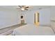 Bedroom with hardwood floors, a ceiling fan, neutral walls, and a walk-in closet at 12218 Avondale Oak Pl, Riverview, FL 33578