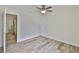 Bedroom featuring faux wood floors, light walls, and a doorway to another room at 12218 Avondale Oak Pl, Riverview, FL 33578