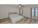 Cozy bedroom with hardwood floors, a ceiling fan, and natural light at 12218 Avondale Oak Pl, Riverview, FL 33578