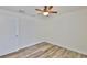 Bedroom featuring wood floors, a ceiling fan, neutral walls, and a door at 12218 Avondale Oak Pl, Riverview, FL 33578