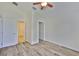 Neutral bedroom with light walls and floors, ceiling fan, and interior doors at 12218 Avondale Oak Pl, Riverview, FL 33578