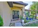 Close-up of a home's entry way, enhanced by elegant plants and decorative pots at 12218 Avondale Oak Pl, Riverview, FL 33578