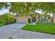 Charming single-story home featuring an attached two-car garage and well-manicured front lawn at 12218 Avondale Oak Pl, Riverview, FL 33578