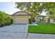 Charming single-story home featuring an attached two-car garage and well-manicured front lawn at 12218 Avondale Oak Pl, Riverview, FL 33578