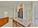 Spacious kitchen featuring an island, breakfast bar, stainless steel refrigerator, and ample cabinet space at 12218 Avondale Oak Pl, Riverview, FL 33578