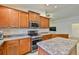 Well-equipped kitchen features stainless appliances, ample counter space, and stylish backsplash at 12218 Avondale Oak Pl, Riverview, FL 33578