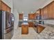 Traditional kitchen showcasing a center island, stainless steel appliances, and granite countertops at 12218 Avondale Oak Pl, Riverview, FL 33578