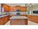 Modern kitchen featuring a kitchen island, stainless steel appliances, and plenty of cabinet space at 12218 Avondale Oak Pl, Riverview, FL 33578
