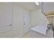White laundry appliances shown in this bright laundry room at 12218 Avondale Oak Pl, Riverview, FL 33578