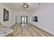 Bright living area with wood-look floors, vaulted ceilings, and backyard access at 12218 Avondale Oak Pl, Riverview, FL 33578