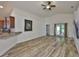 Bright living area with wood-look floors, vaulted ceilings, and backyard access at 12218 Avondale Oak Pl, Riverview, FL 33578