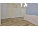Open living room space with neutral walls, wood flooring, and plenty of natural light at 12218 Avondale Oak Pl, Riverview, FL 33578
