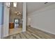 Spacious living room featuring wood-look flooring, vaulted ceiling, and access to the backyard at 12218 Avondale Oak Pl, Riverview, FL 33578