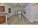 Bright living area with wood-look floors, vaulted ceilings, and backyard access at 12218 Avondale Oak Pl, Riverview, FL 33578