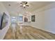 Spacious living room featuring wood-look floors and an open layout to the kitchen at 12218 Avondale Oak Pl, Riverview, FL 33578