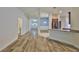 Inviting open floorplan with stylish wood-look flooring and views of the modern kitchen at 12218 Avondale Oak Pl, Riverview, FL 33578