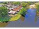 Aerial view showcasing the condo's proximity to a serene lake and lush landscaping at 1980 Tahitian Pl # 10, Dunedin, FL 34698