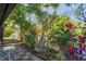Serene backyard with lush vegetation and views of a tranquil lake at 1980 Tahitian Pl # 10, Dunedin, FL 34698
