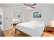 Spacious bedroom has mirrored closet, ceiling fan and hardwood floors at 1980 Tahitian Pl # 10, Dunedin, FL 34698