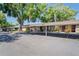 The exterior view shows the charming condo buildings with dedicated covered parking spaces at 1980 Tahitian Pl # 10, Dunedin, FL 34698