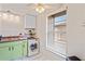 The kitchen also features a combo washer-dryer unit, lots of light, and cabinet storage at 1980 Tahitian Pl # 10, Dunedin, FL 34698