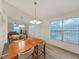 Dining room featuring a window, laminate floors, and chandelier lighting at 3964 Dream Oak Pl # 203, Tampa, FL 33613