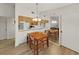 Cozy dining room with wooden table and chairs, adjacent to open kitchen area at 3964 Dream Oak Pl # 203, Tampa, FL 33613