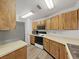 Kitchen featuring wooden cabinets, stainless steel sink, and modern appliances at 3964 Dream Oak Pl # 203, Tampa, FL 33613