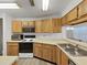 Kitchen featuring wooden cabinets, stainless steel sink, and modern appliances at 3964 Dream Oak Pl # 203, Tampa, FL 33613